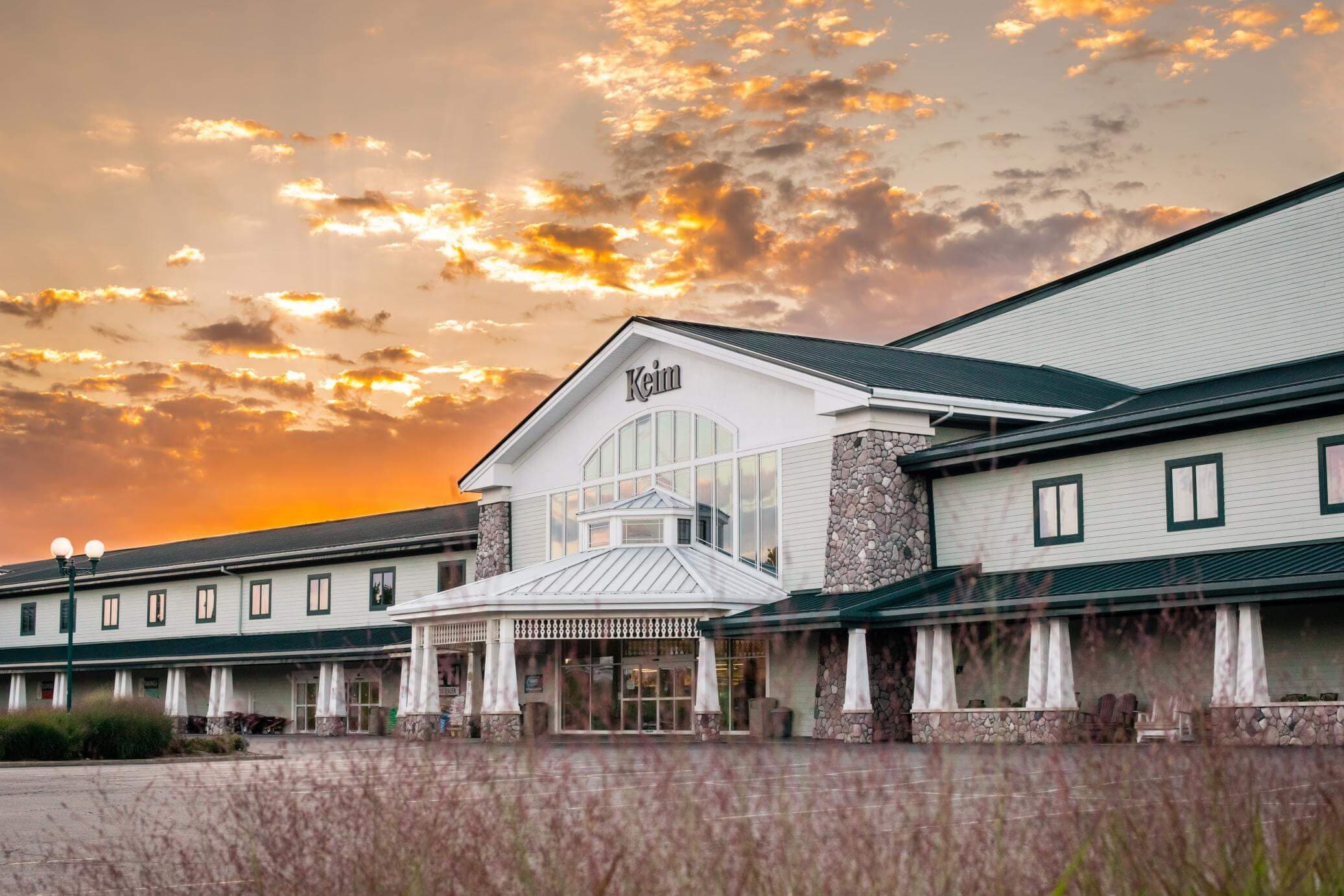 Wide-shot of the exterior Keim store front, sunset above